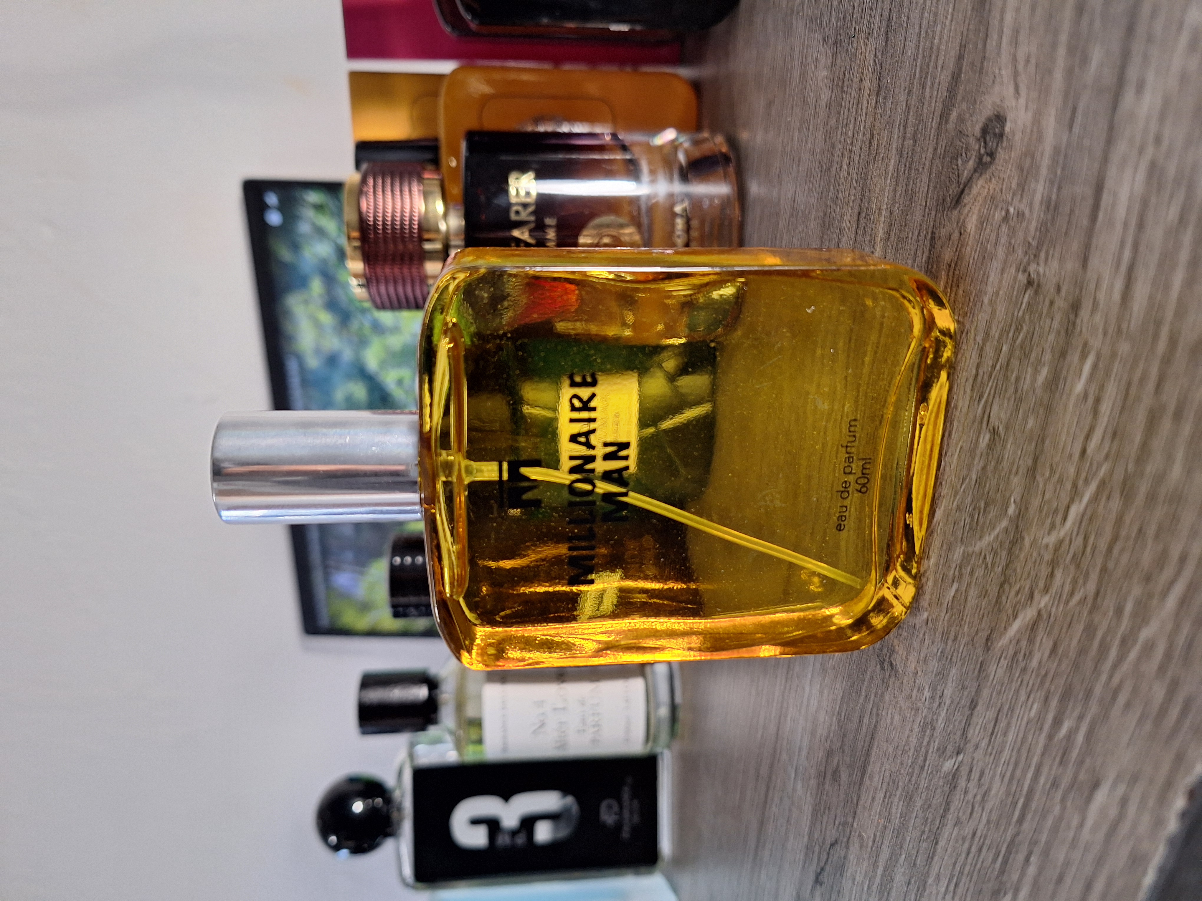 Millionaire Men perfume bottle with sleek black glass and silver accents